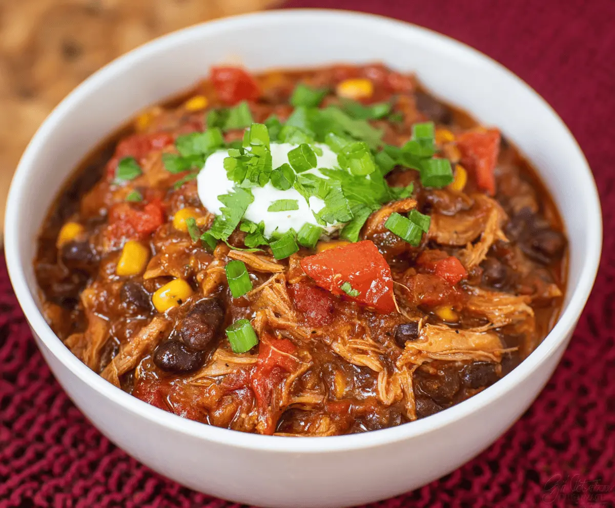 Deliciously seasoned pork roast chili served in a bowl with fresh toppings and garnishes