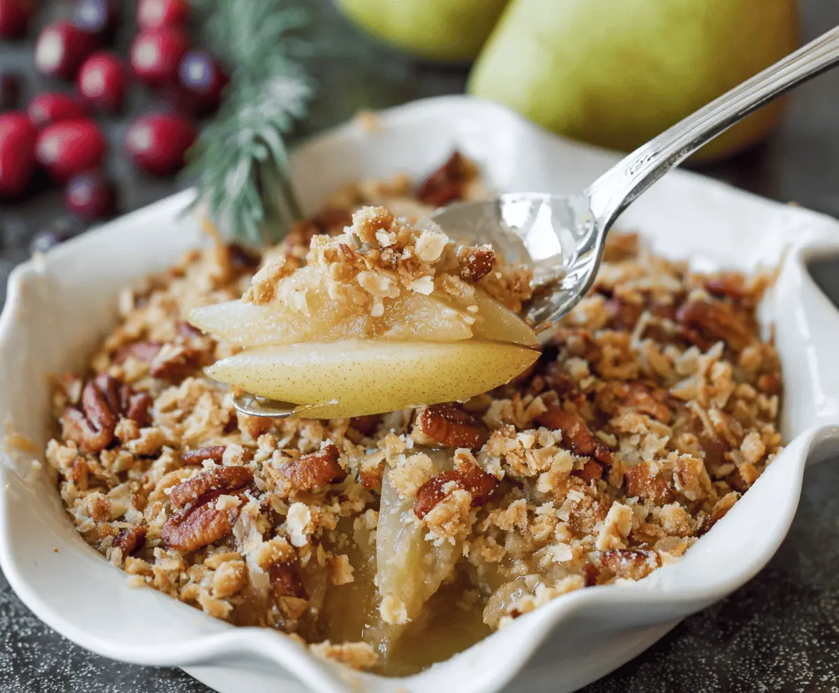 Delicious Holiday Pear Crumble with golden-brown topping and fresh pear slices for festive dessert
