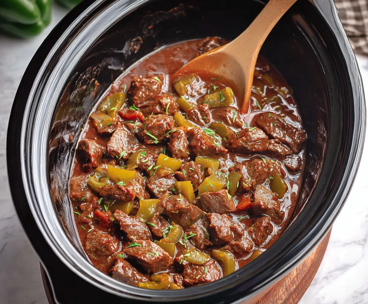 Delicious Crockpot Mississippi Steak Bites served with fresh herbs and side vegetables.